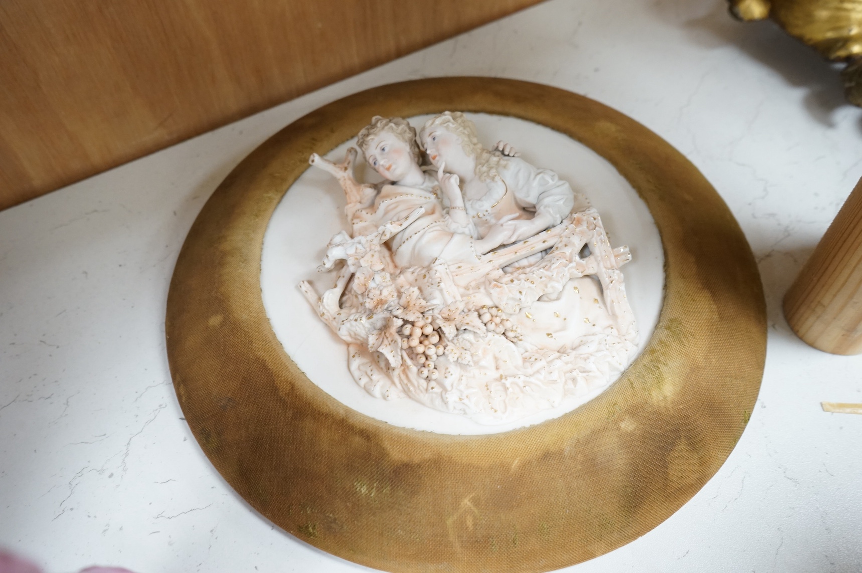 A pair of German porcelain figures, and a pair of circular bisque plaques, 26.5cm diameter. Condition - good